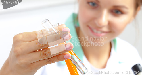 Image of pretty doctor examining contents