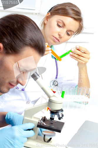 Image of Female researcher analyzes tubes