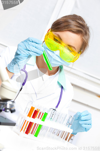 Image of woman doctor looking at a test tube
