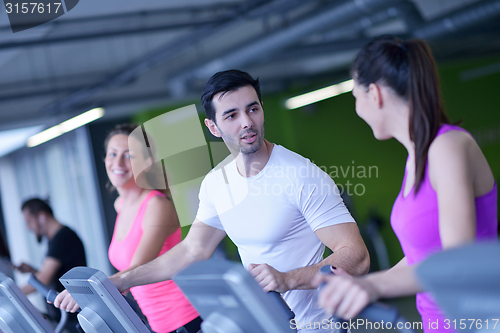 Image of Group of people running on treadmills
