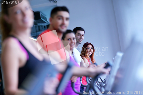 Image of Group of people running on treadmills