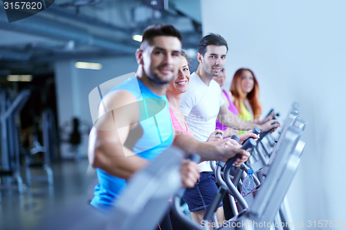 Image of Group of people running on treadmills