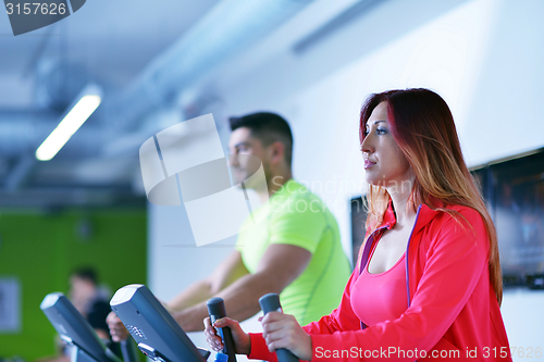 Image of Group of people running on treadmills