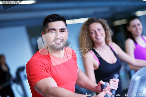 Image of Group of people running on treadmills