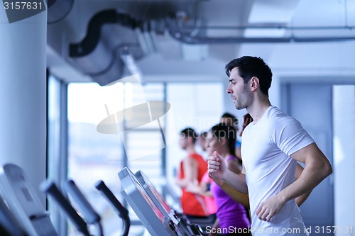 Image of Group of people running on treadmills