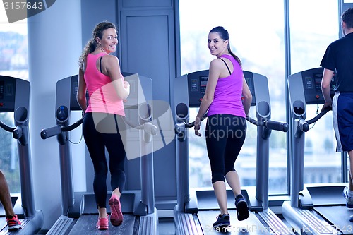 Image of Group of people running on treadmills