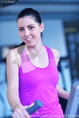 Image of woman exercising on treadmill in gym