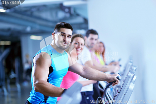 Image of Group of people running on treadmills