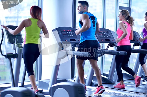 Image of Group of people running on treadmills
