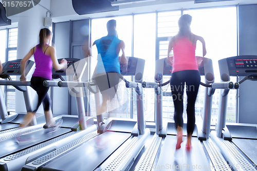 Image of Group of people running on treadmills