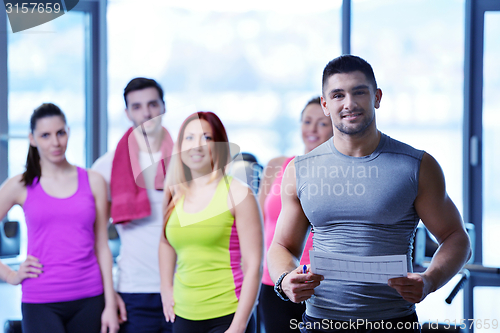 Image of Group of people exercising at the gym