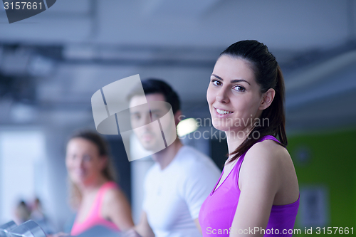 Image of Group of people running on treadmills