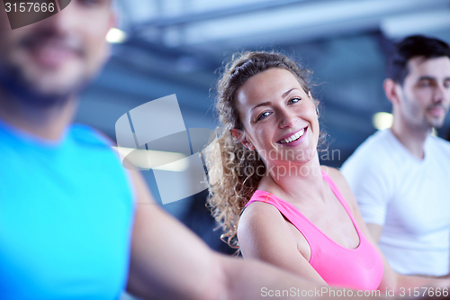 Image of Group of people running on treadmills