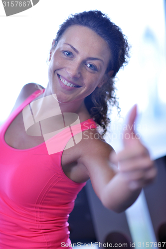 Image of woman exercising on treadmill in gym