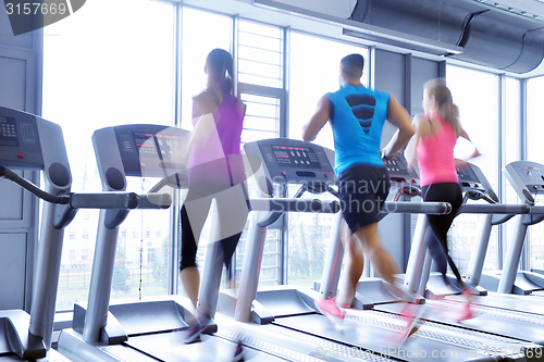 Image of Group of people running on treadmills