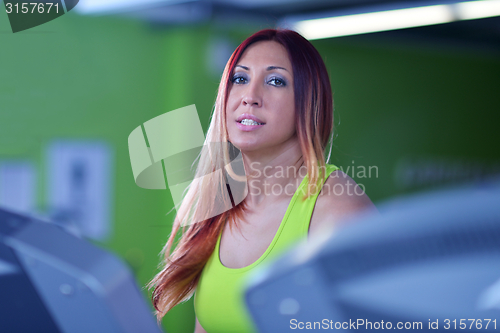 Image of woman exercising on treadmill in gym