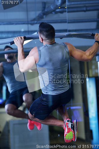 Image of handsome man exercising at the gym
