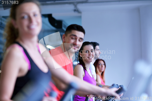 Image of Group of people running on treadmills