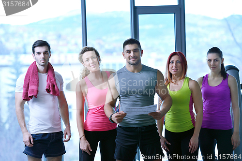 Image of Group of people exercising at the gym