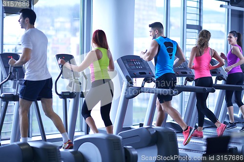 Image of Group of people running on treadmills