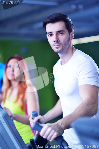 Image of Group of people running on treadmills