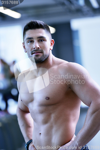 Image of handsome man exercising at the gym