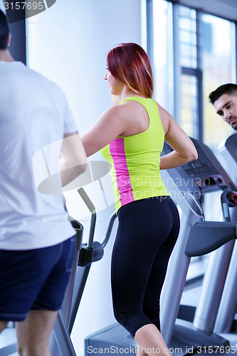 Image of Group of people running on treadmills