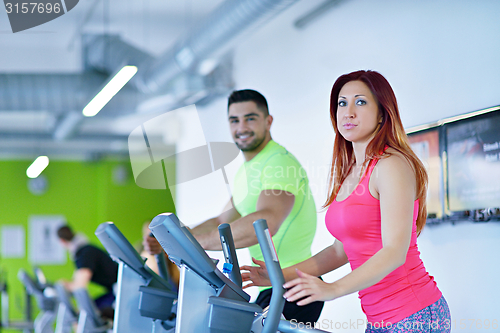 Image of Group of people running on treadmills