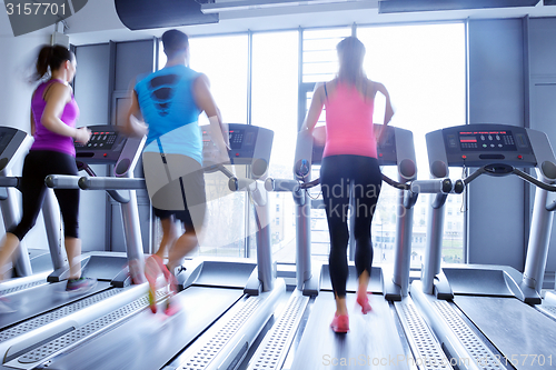 Image of Group of people running on treadmills