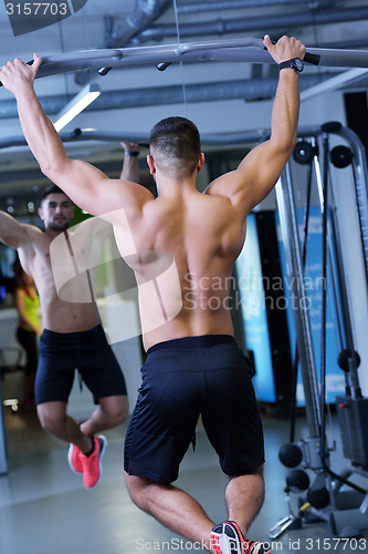 Image of handsome man exercising at the gym