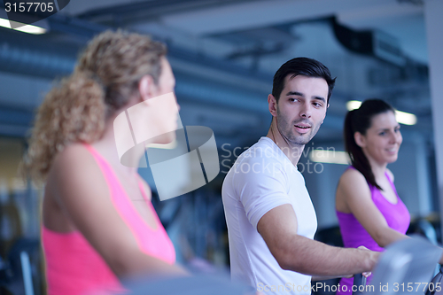 Image of Group of people running on treadmills