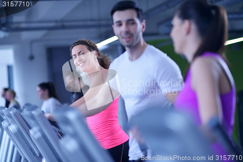 Image of Group of people running on treadmills