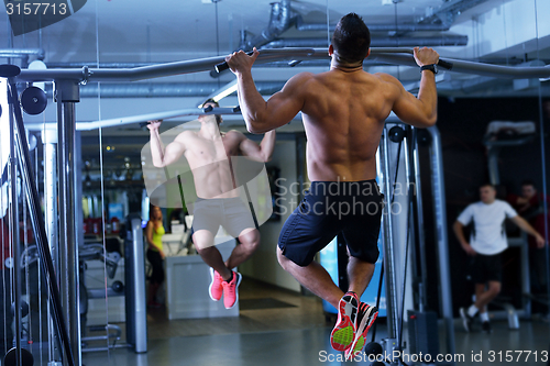 Image of handsome man exercising at the gym