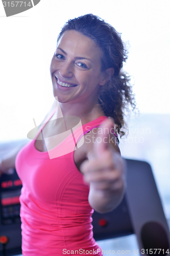 Image of woman exercising on treadmill in gym