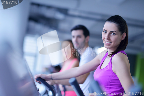 Image of Group of people running on treadmills