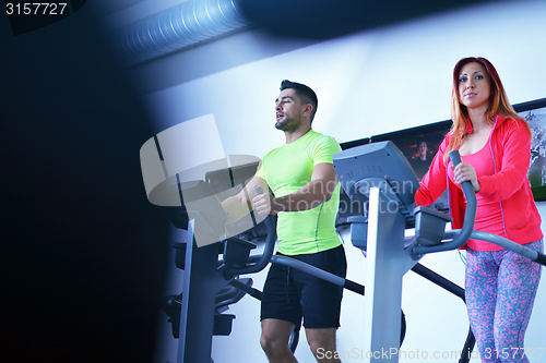 Image of Group of people running on treadmills