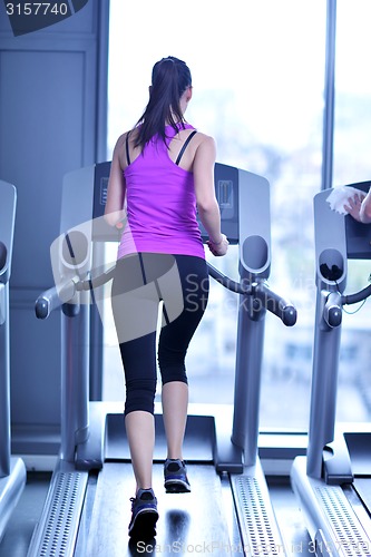 Image of woman exercising on treadmill in gym