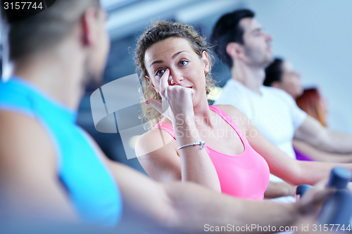 Image of Group of people running on treadmills