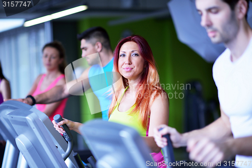 Image of Group of people running on treadmills