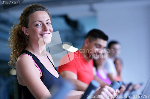 Image of Group of people running on treadmills