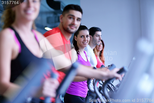 Image of Group of people running on treadmills