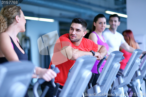 Image of Group of people running on treadmills