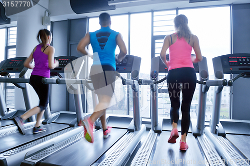 Image of Group of people running on treadmills