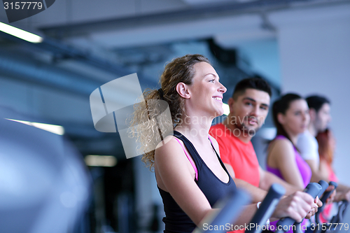 Image of Group of people running on treadmills