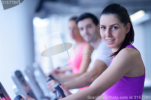 Image of Group of people running on treadmills