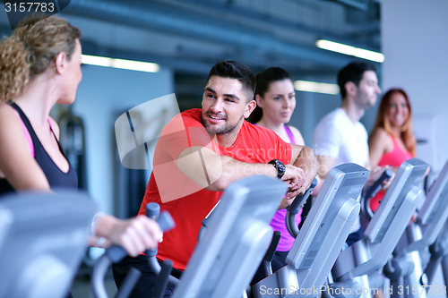 Image of Group of people running on treadmills