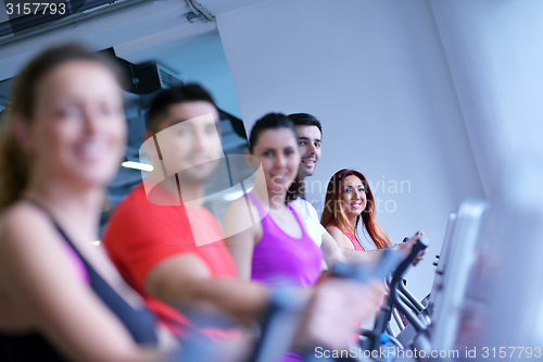 Image of Group of people running on treadmills