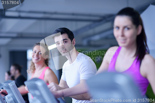 Image of Group of people running on treadmills