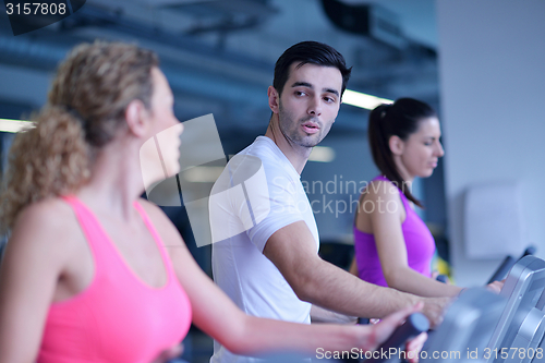 Image of Group of people running on treadmills