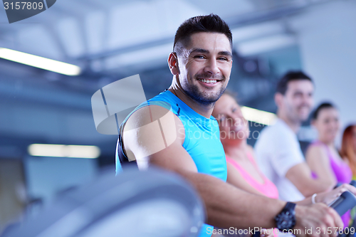 Image of Group of people running on treadmills